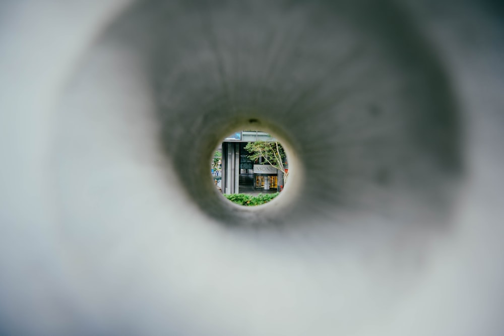 a view of a building through a hole in the wall