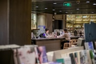 A mentor and mentee sharing a meaningful conversation, surrounded by books and memories.