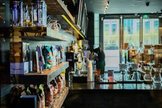 A cozy coffee shop corner with bags of fresh coffee beans and brewing equipment.