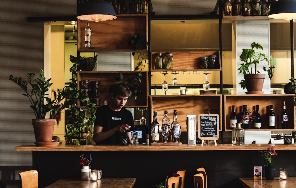 man standing in front of bar table