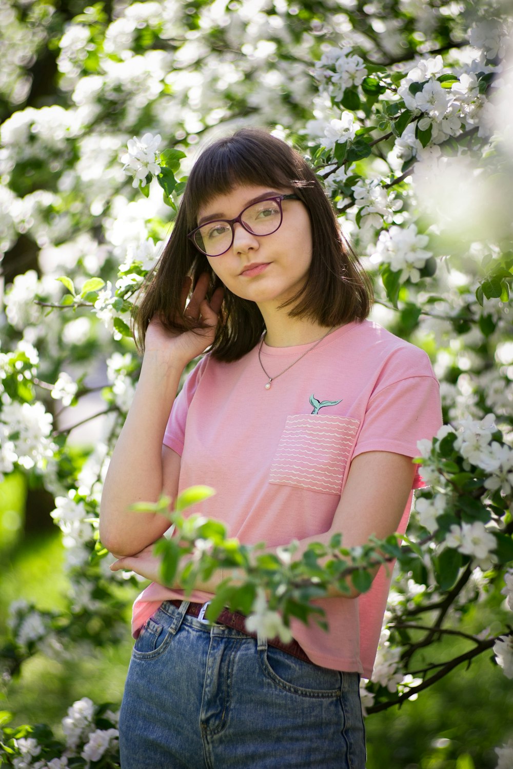 woman standing near white flowernig tree