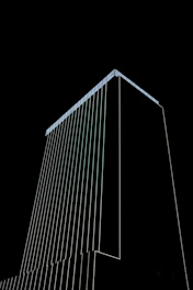 Modern architectural lines forming a sleek, geometric building silhouette against a dark background.