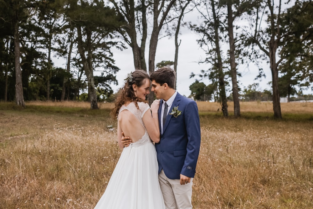 man and woman facing each other on pasture during daytime