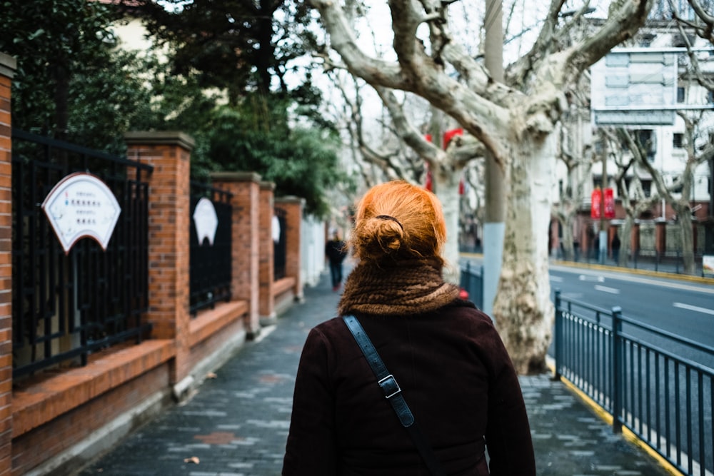 woman walking beside tree