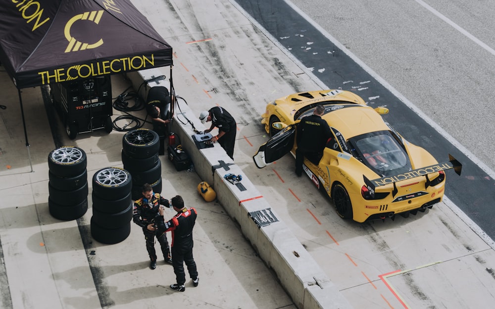 red sports car beside pit stop