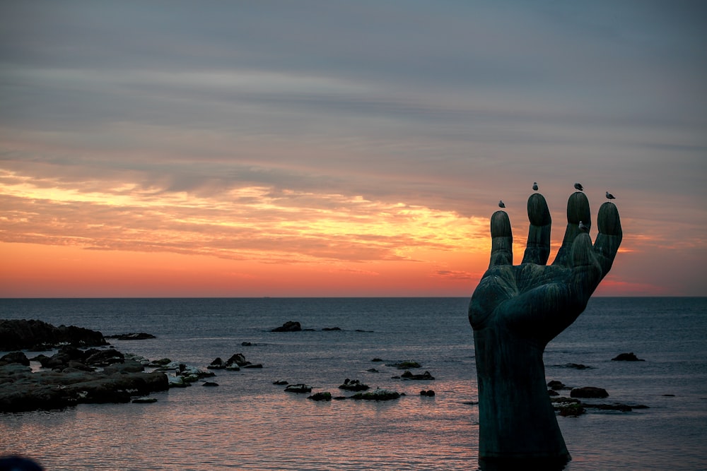 hand statue in seashore