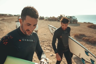 2 men with surf boards in beach