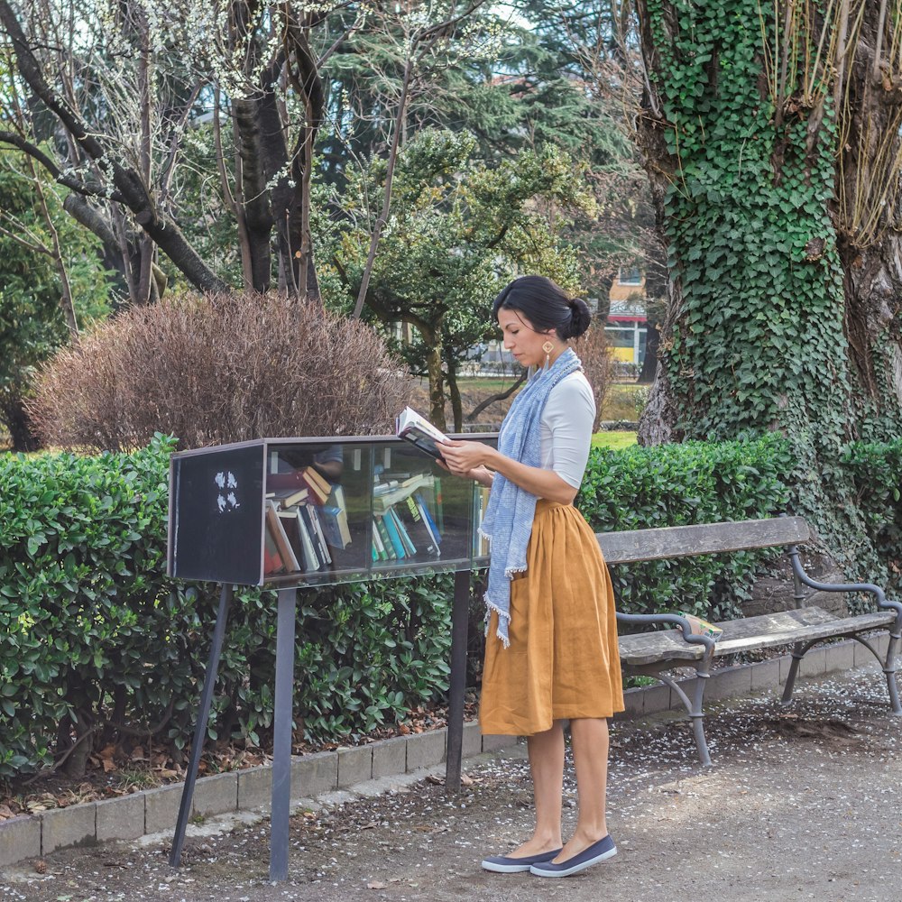 woman reads books at the park