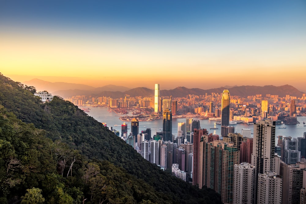 green mountain across city buildings