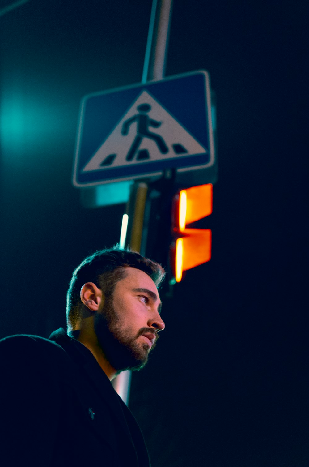 man standing near traffic light