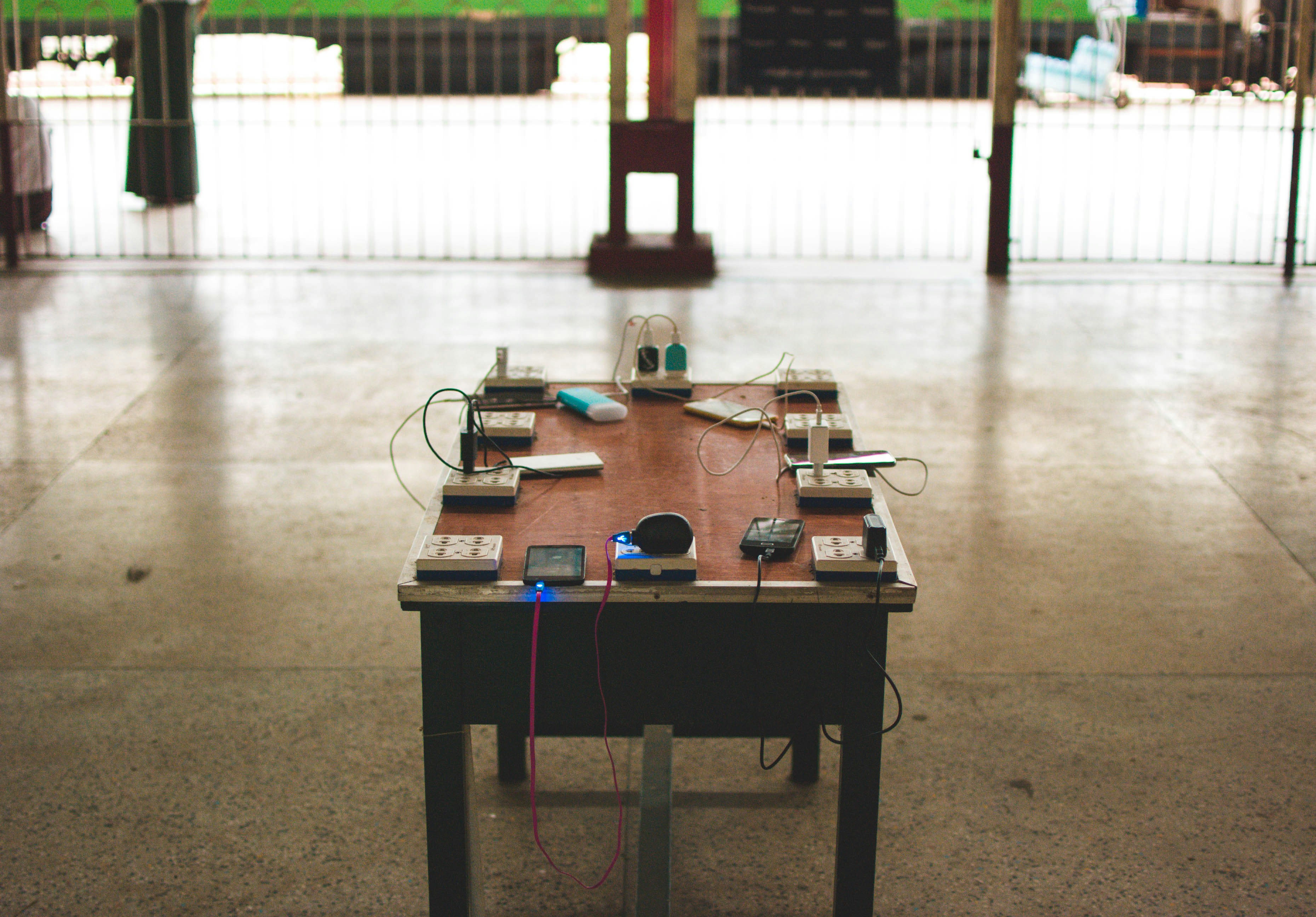 Power sockets and travel adapters on brown wooden table