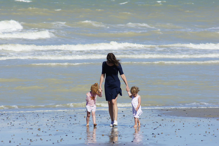 A mom walking on the beach with her two children