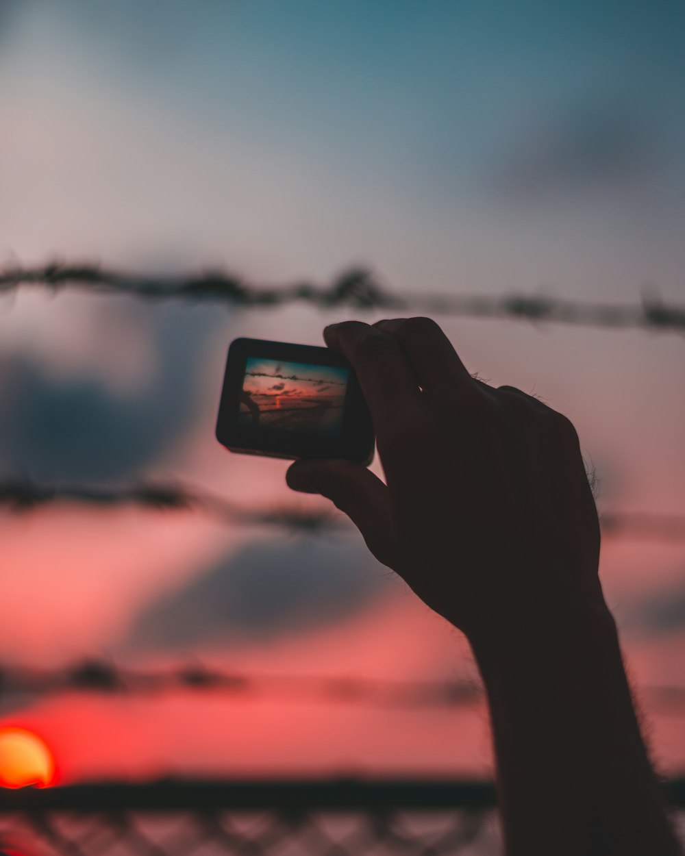 selective focus photo of person holding action camera