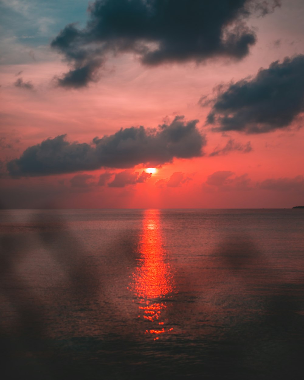 orange setting sun over sea