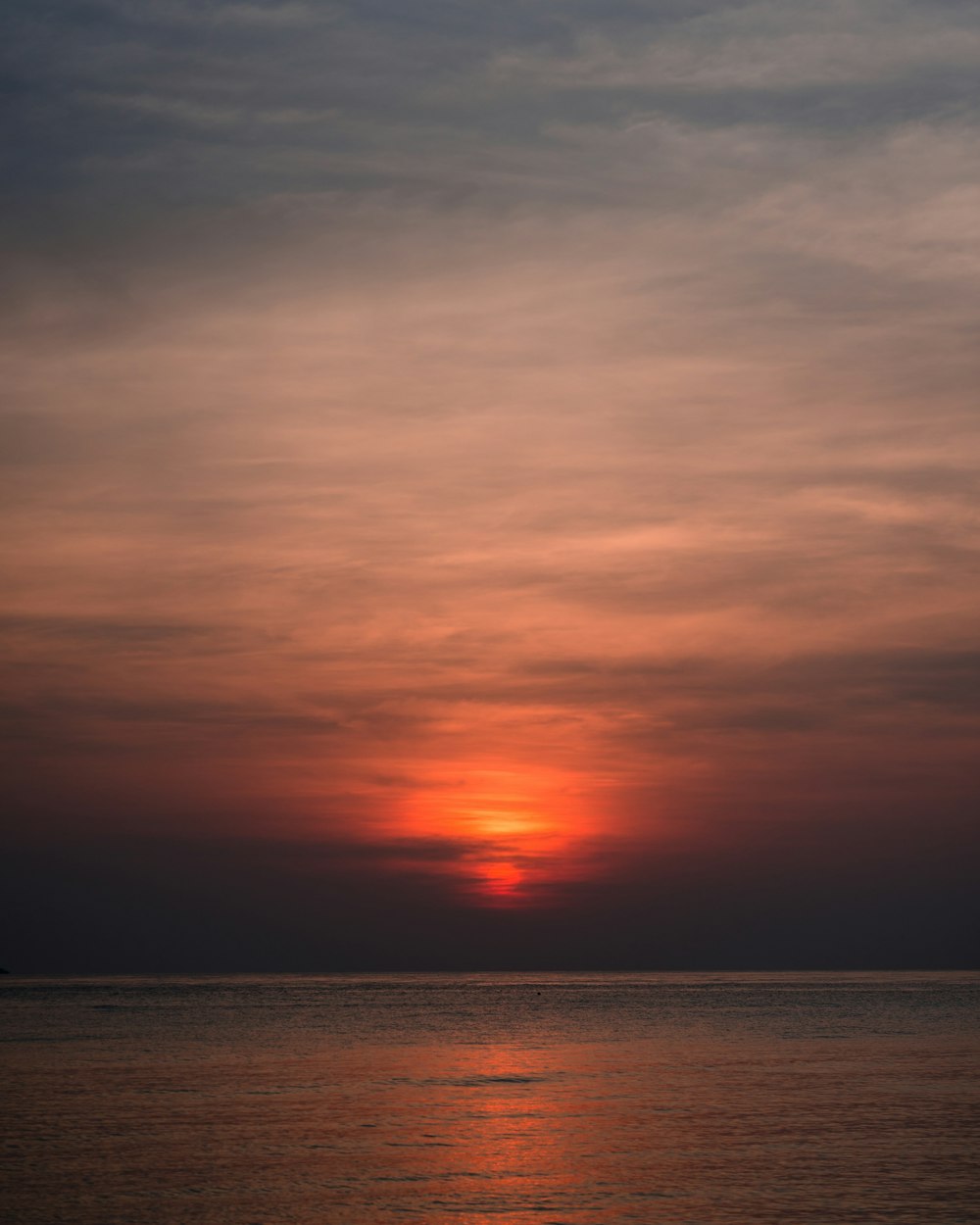 body of water under cloudy sky during golden hour