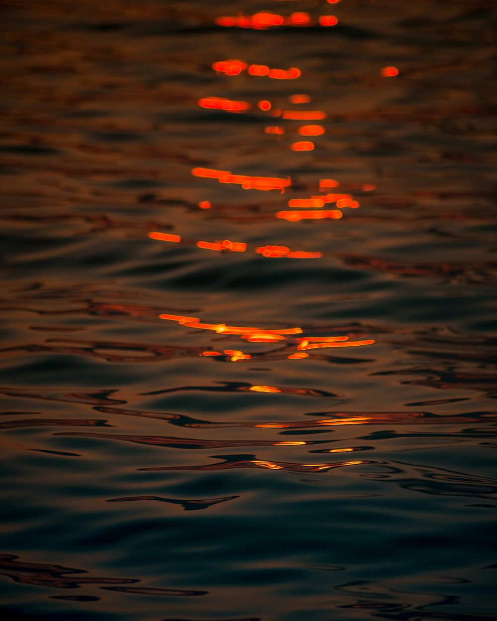body of water with reflection of sun