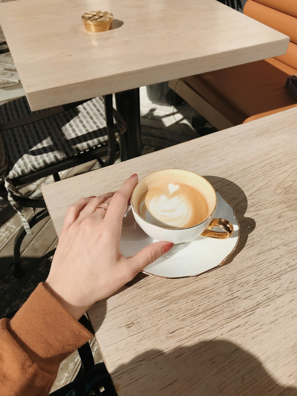 person holding cappuccino cup