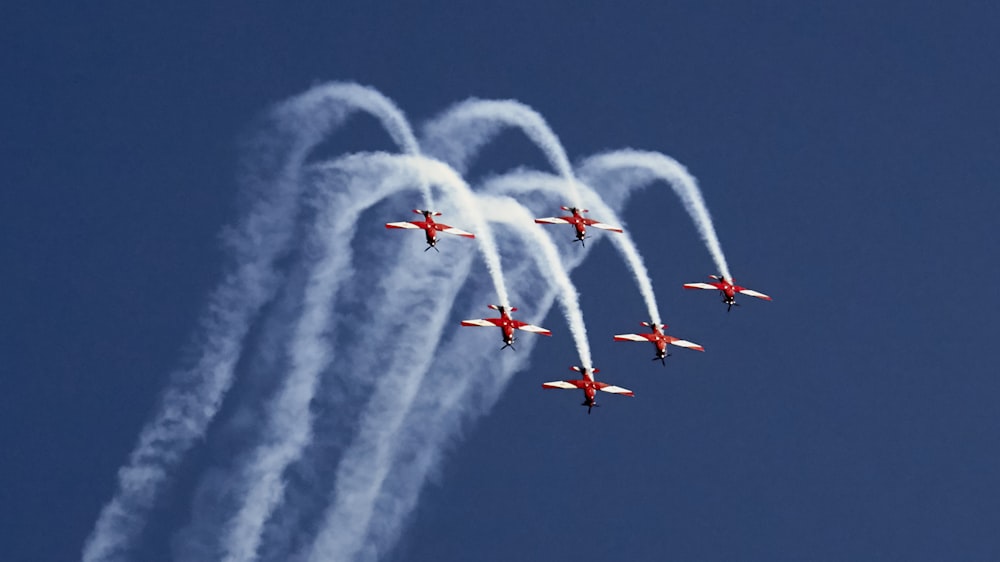 six airplanes with white smokes