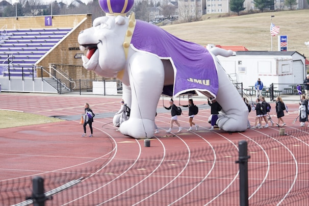Inflatable pillar with bold company colors standing tall in a sports event setting.