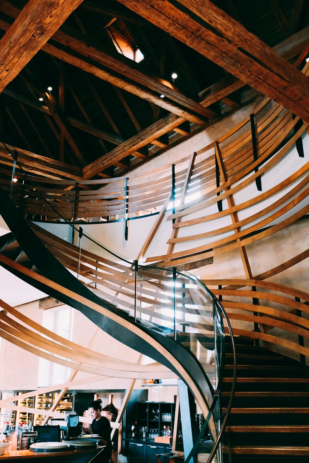 woman standing under stairs inside room