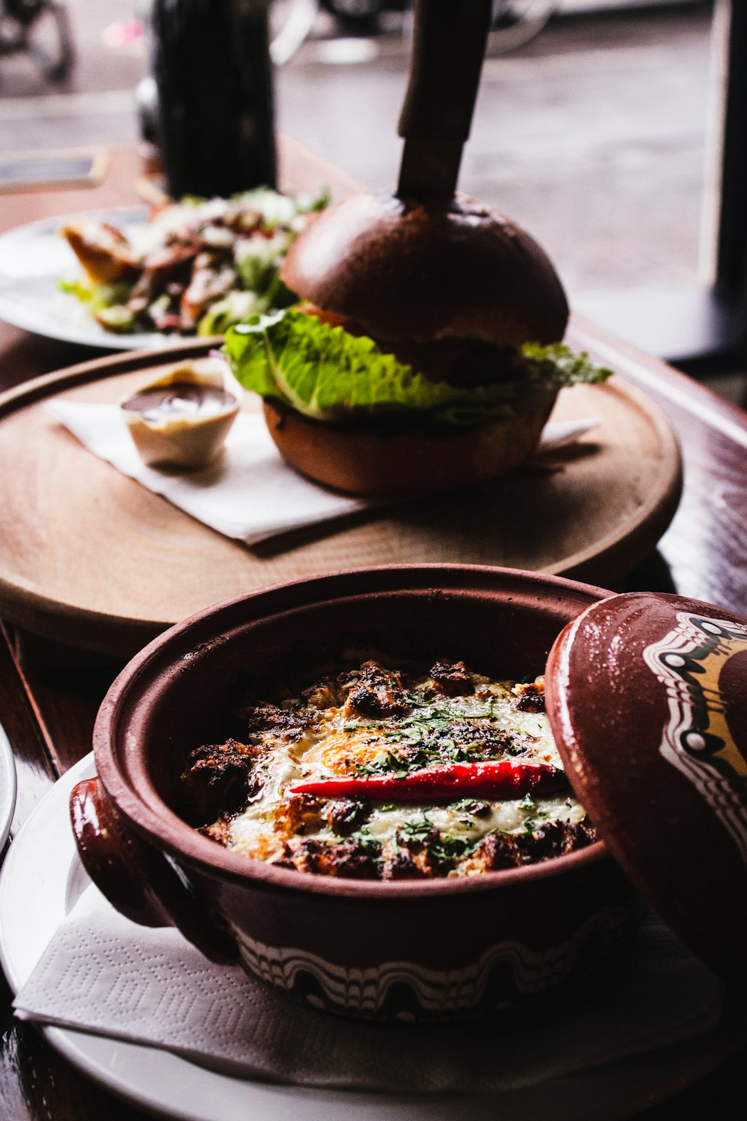 round brown ceramic bowl on table with cooked food