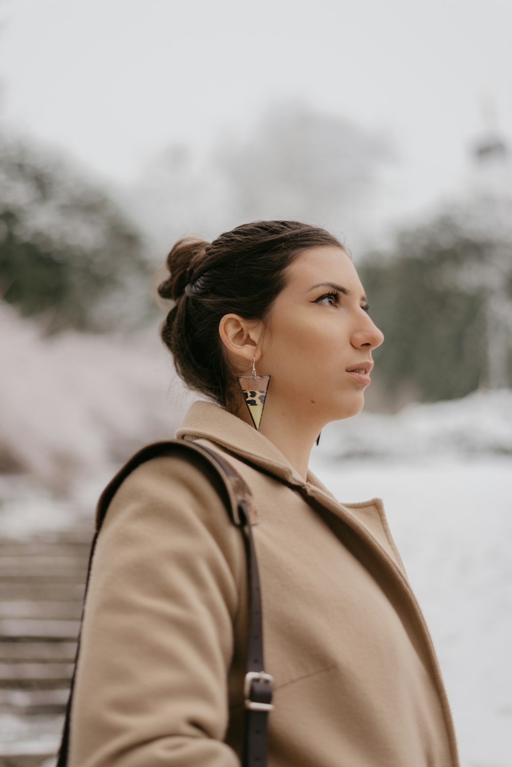 selective focus photography of woman in brown coat