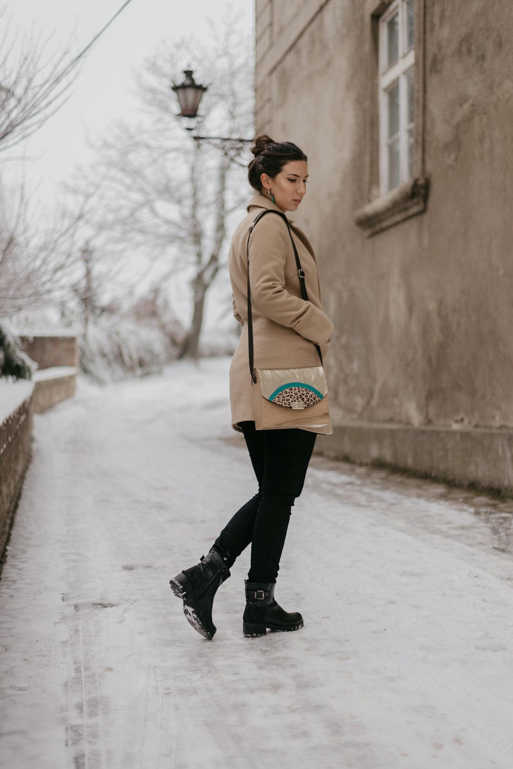 woman standing beside concrete house