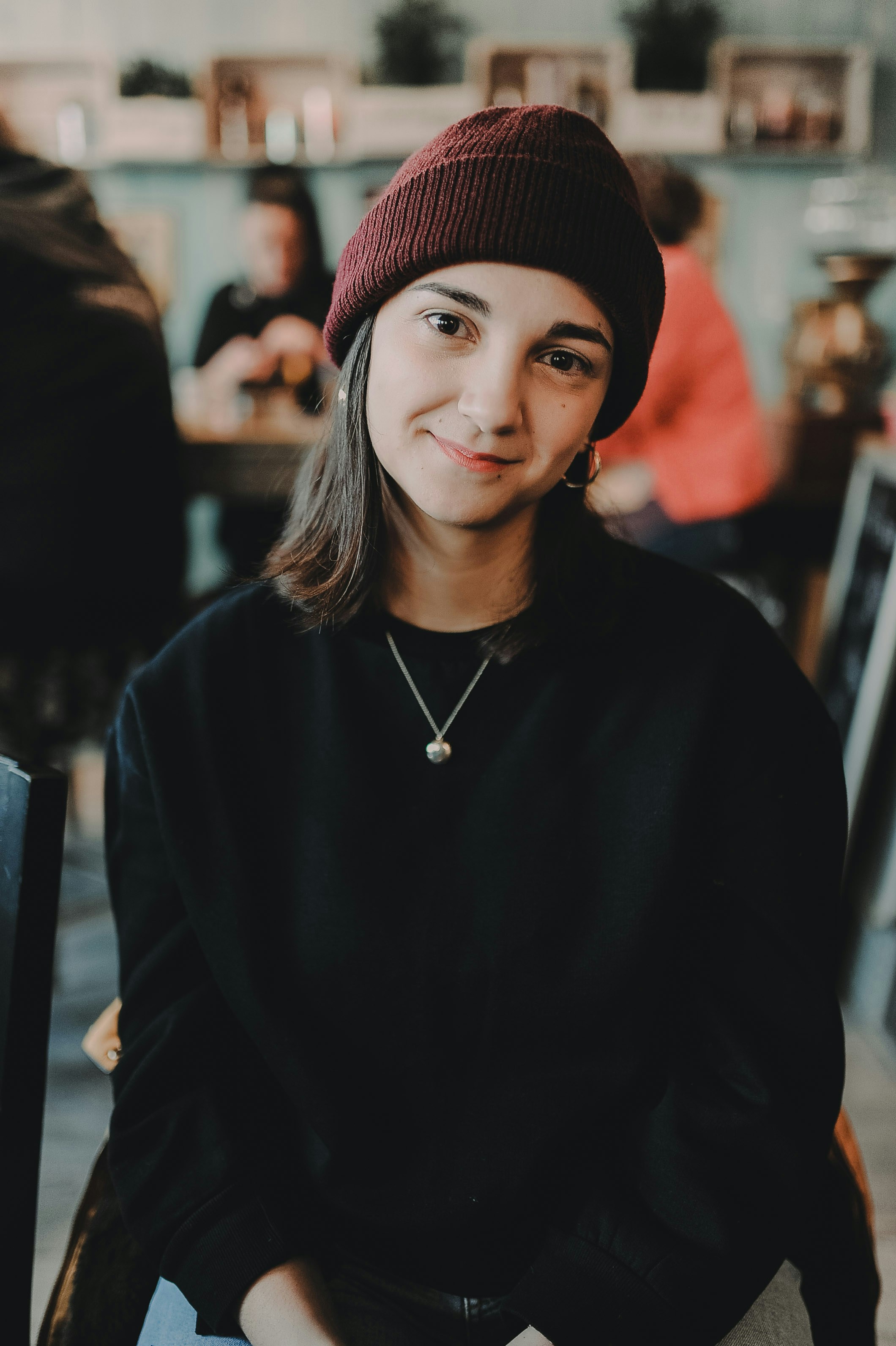 woman sitting on brown wooden chair