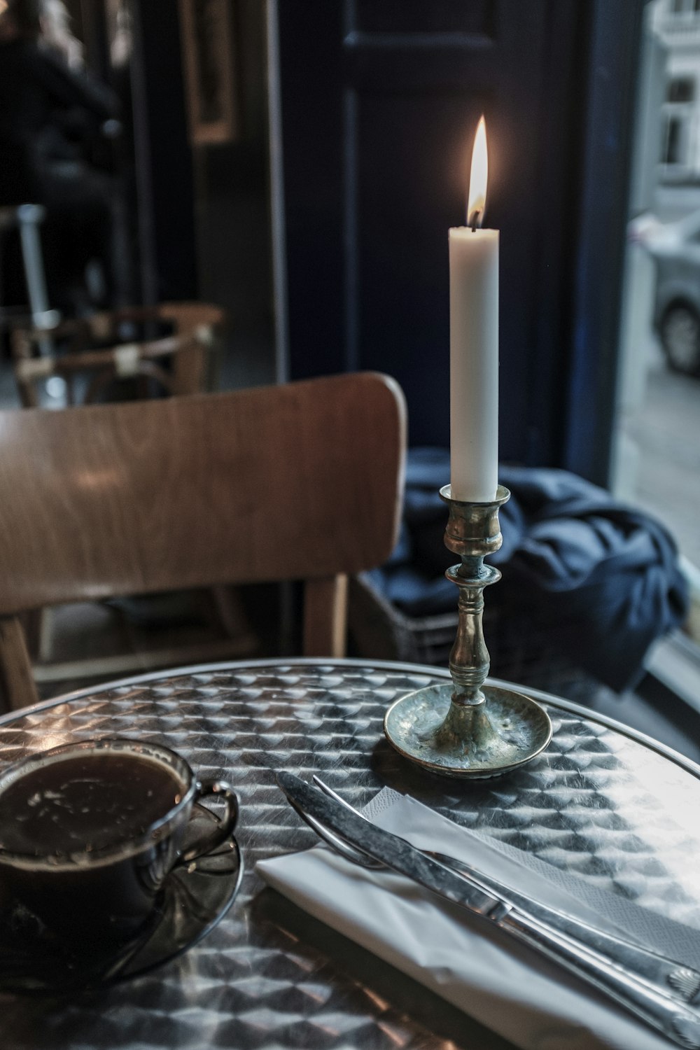 lighted candle on table inside room