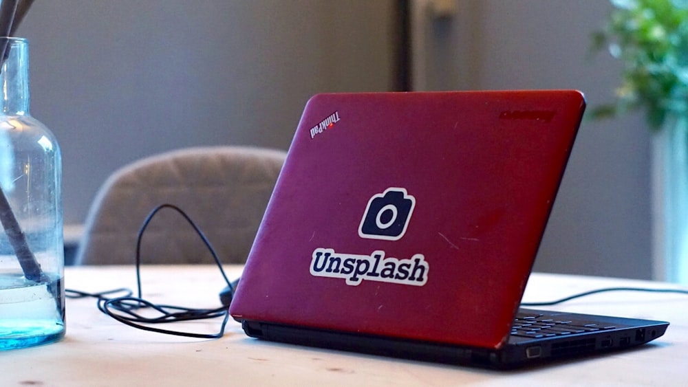 red and black Lenovo ThinkPad on table