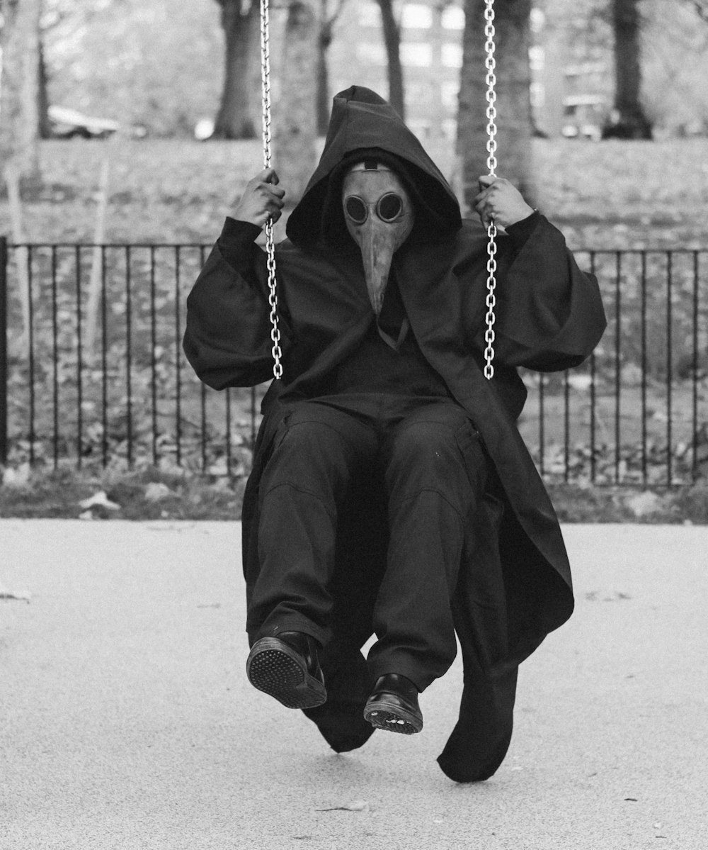 man wearing mask on swing chair