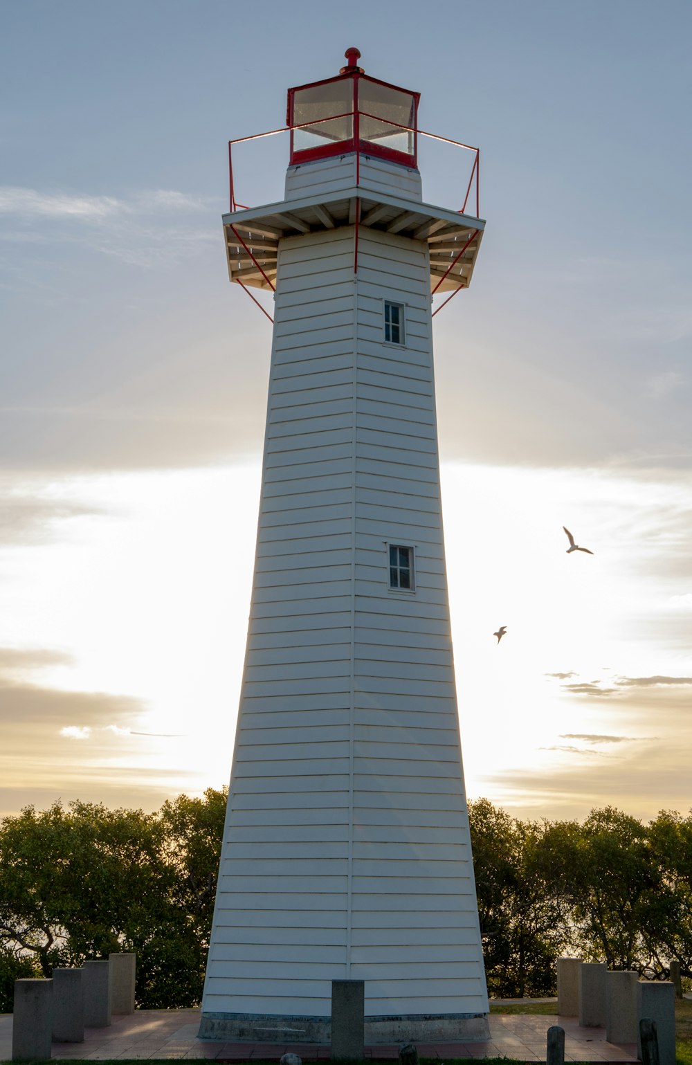 white lighthouse under cloudy sky