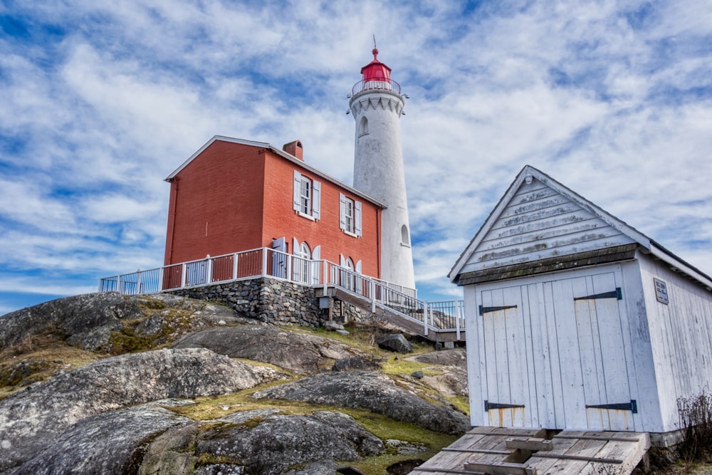 lighthouse beside brown barn