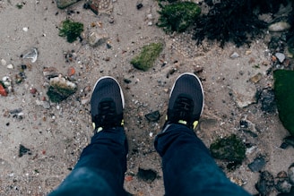 A pair of lightweight wind-ready sneakers on a rocky outdoor trail.
