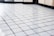 Bright, spotless kitchen tiles with gleaming grout lines after cleaning.