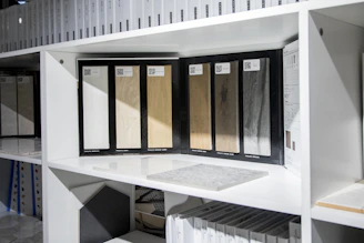 Various samples of window and door materials displayed on a wooden workbench.