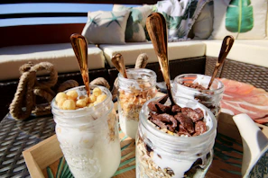 An inviting spread of healthy snacks including nuts, berries, and yogurt in glass jars