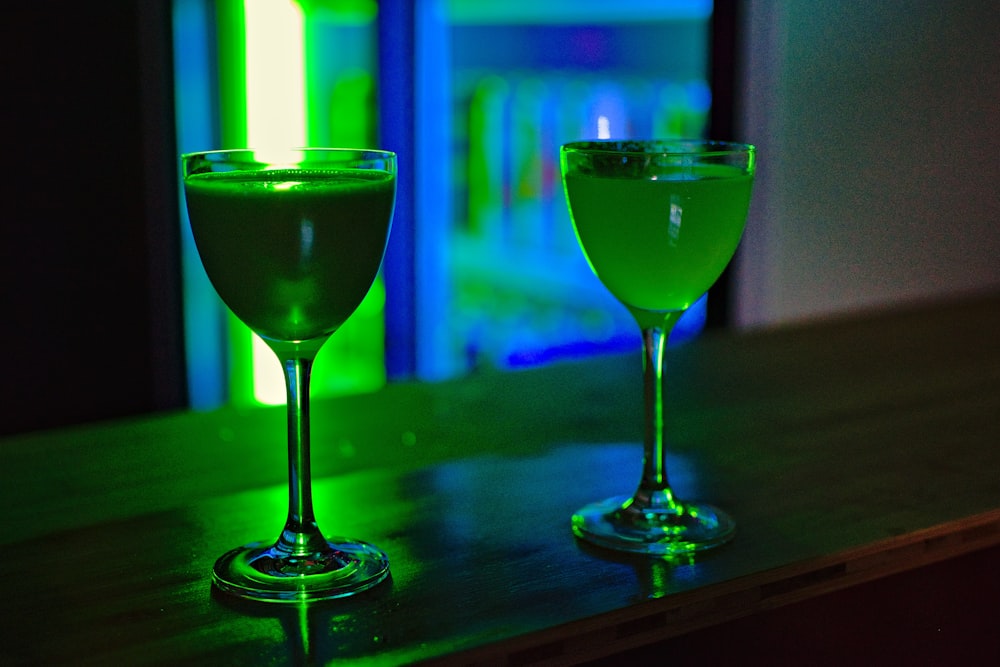two long-stem wine glasses on counter table