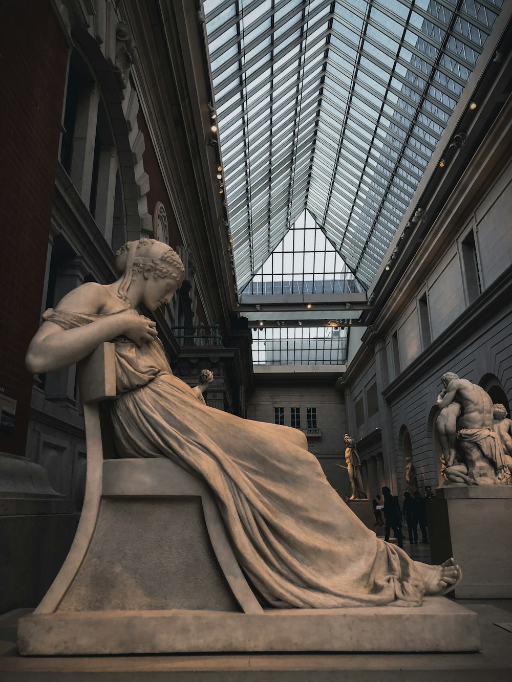 woman's concrete statue inside museum