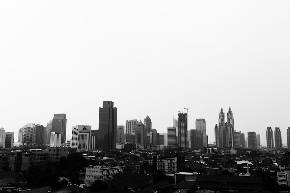 grayscale photo of high rise buildings at daytime