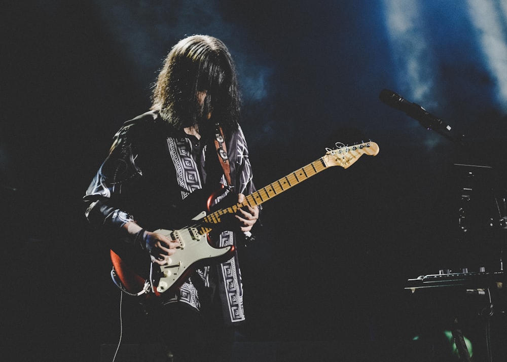 guitarist playing guitar on stage
