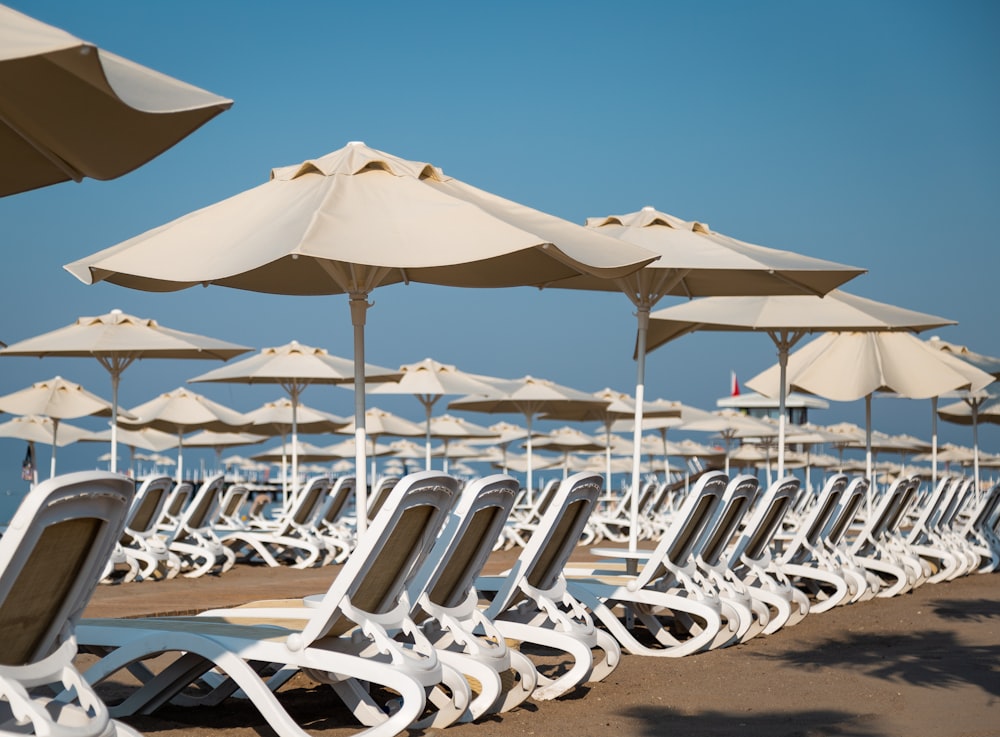 white patio umbrellas and loungers