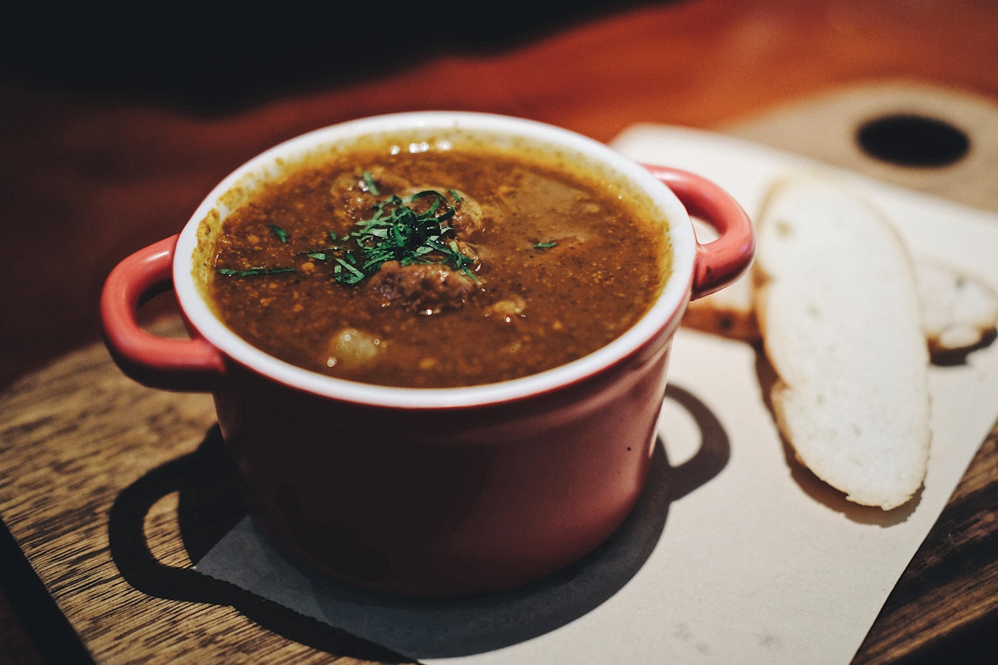 Golden turmeric lentil soup in a bowl with fresh cilantro and lemon
