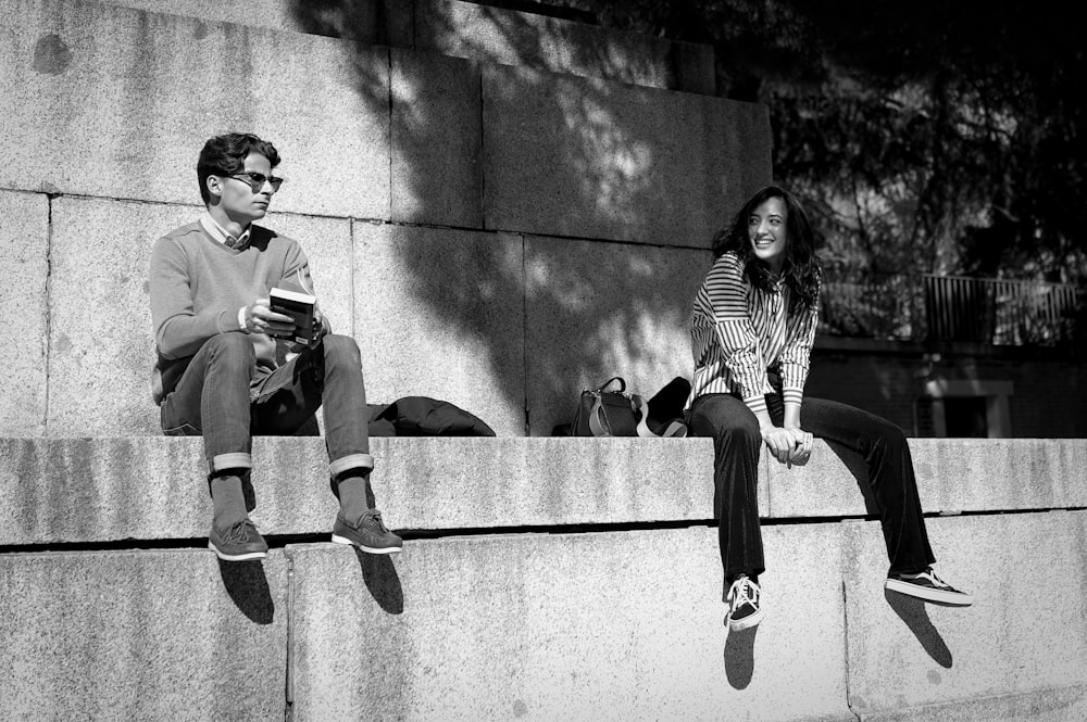 smiling woman looking on man sitting beside during daytime