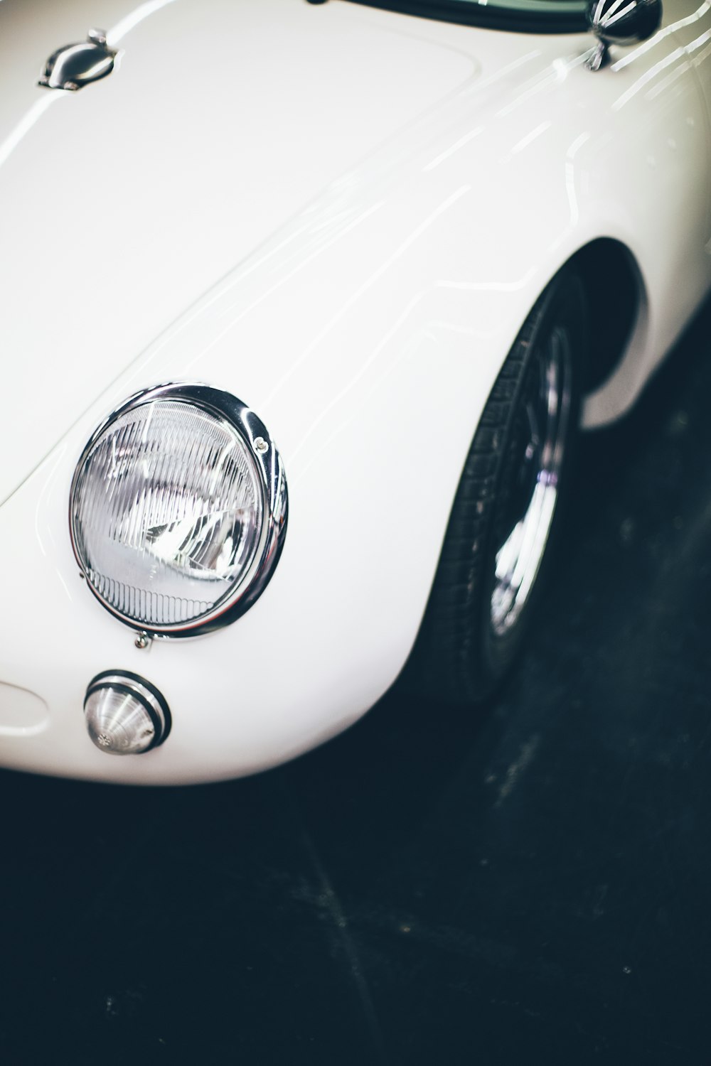 white vehicle parked on black pavement