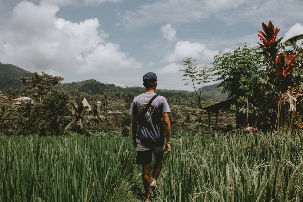 man walking on grass field