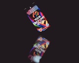 A smartphone displays a colorful, abstract wallpaper with the motivational text 'YOUR ONLY LIMIT IS YOU' on a dark background. The time shown on the screen is 2:00. The phone's reflection is visible below, creating an interesting visual effect.