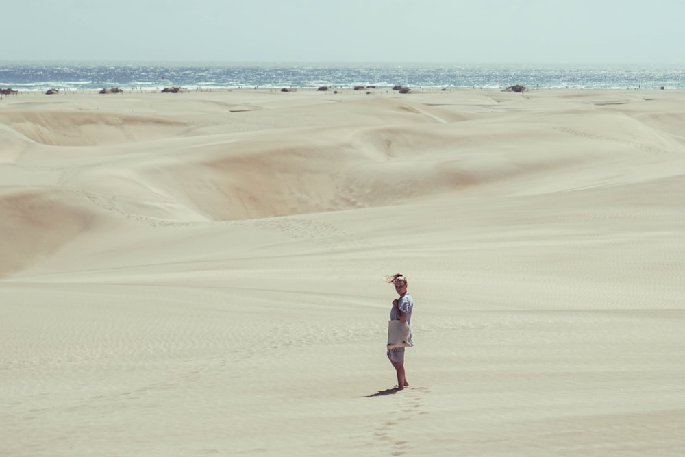 person standing in desert during daytime