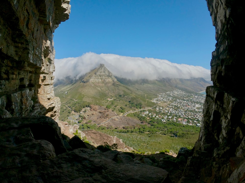 clouds above hill under clear blue sky at daytime