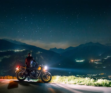 man siting on motorcycle at night